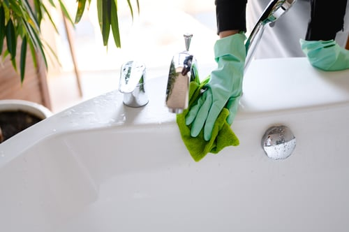 Routine cleaning of a bathroom sink and faucet